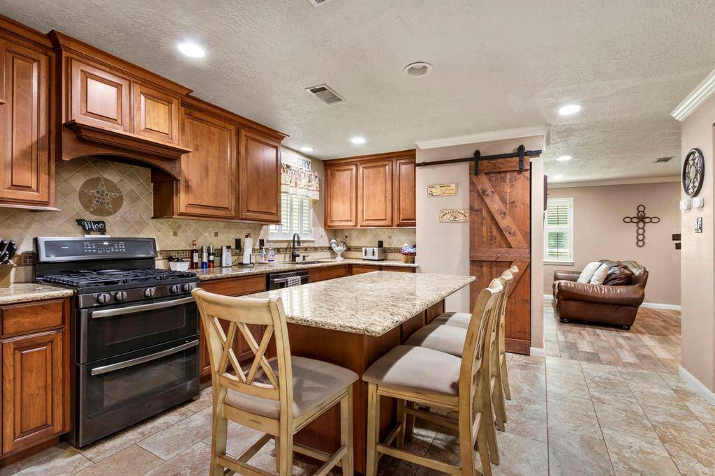 Kitchen view from entry to utility room and butler's pantry.