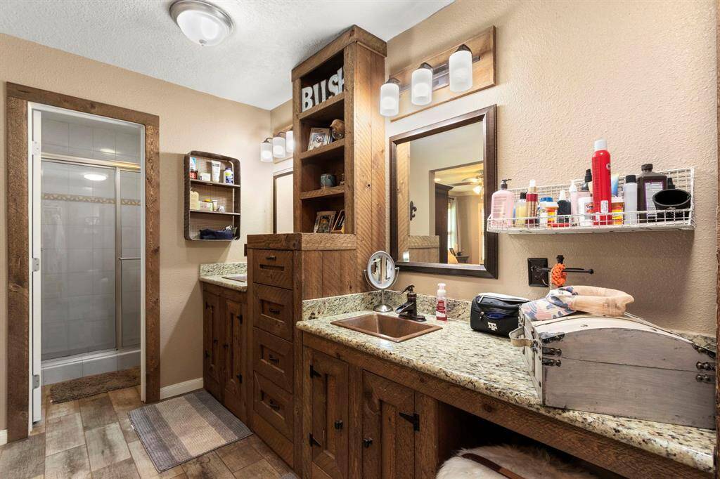 Master bathroom with more custom cabinetry, double hammered copper sinks, granite counter tops and lots of light.