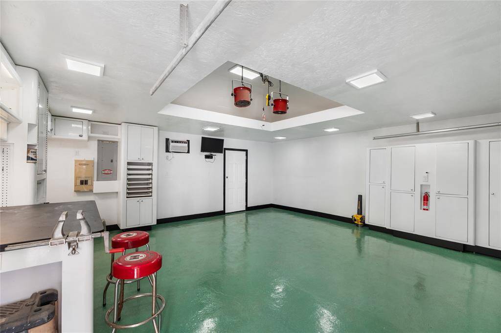 This Garage is a mechanic's dream! With ample lighting, a TV, and climate control, you'll be comfortable working on projects year-round