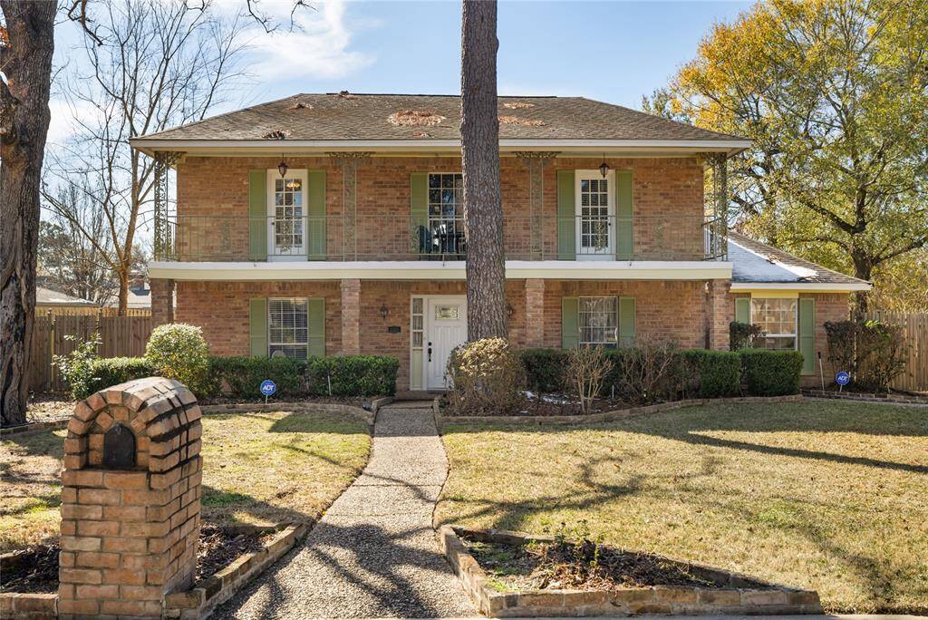 The home features a porch and balcony spanning the entire front.
