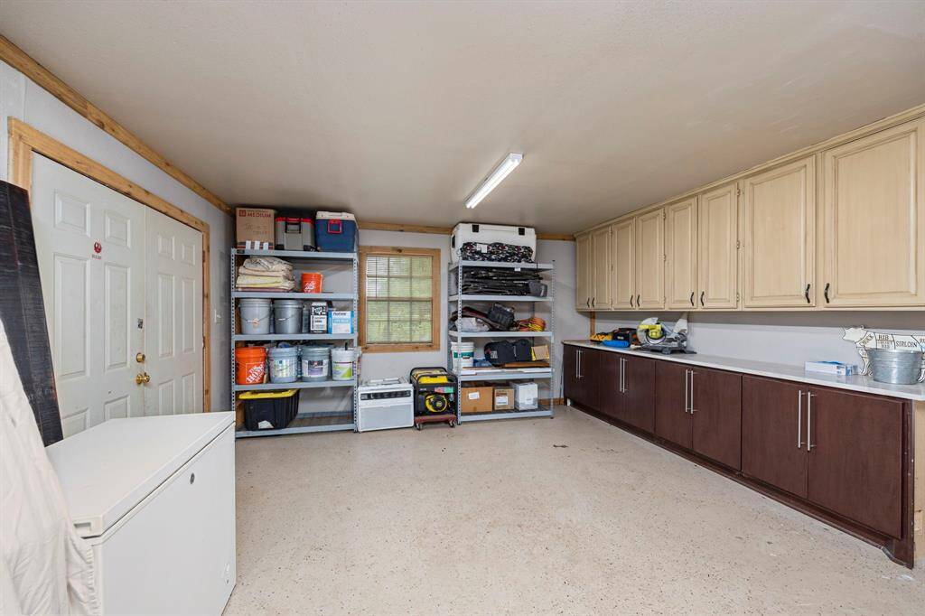 View of Garage workshop/quarters from the bath/kitchen area. Double doors lead to back patio.