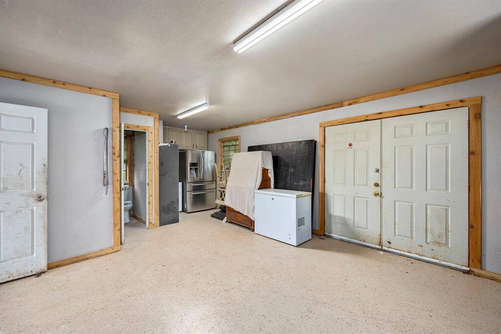 View of double back doors and kitchen area.
