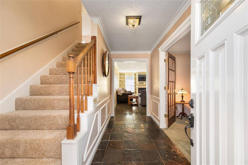 Stepping into the home you'll find the beautiful slate floors and paneled walls
