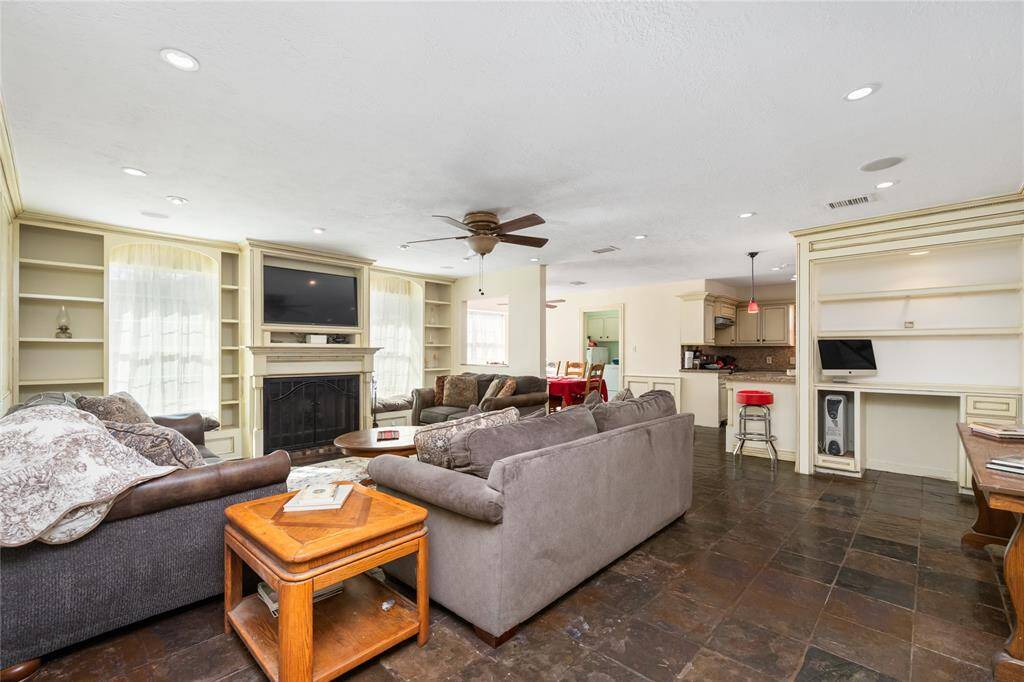 Once in the Family Room, you'll find a built-in workstation and shelving throughout, with a gas log fireplace to keep everyone warm during chilly winters.