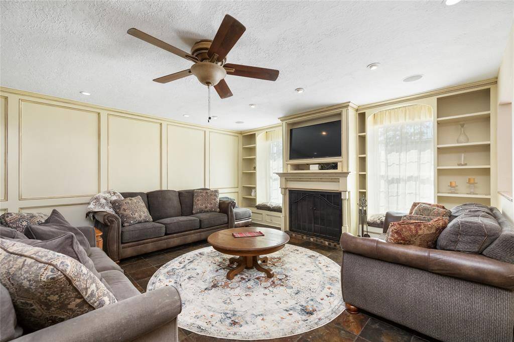 The paneling on the wall of the Family Room coordinate with the kitchen cabinets, bring cohesion into the design of the home