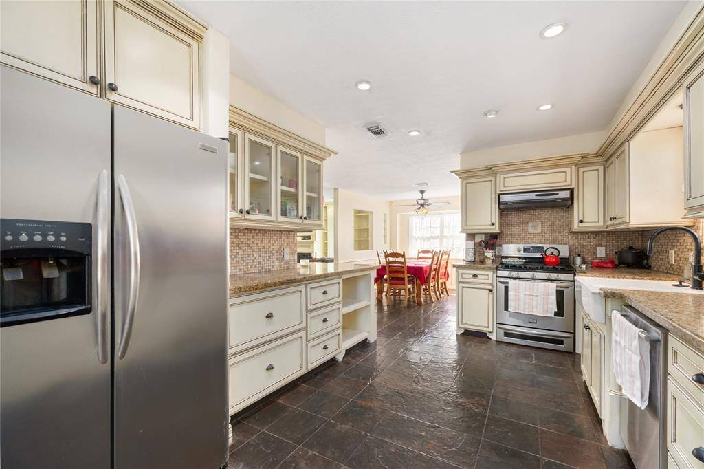 Glass upper cabinets display your collectables, with tons of additional storage for all of your cooking supplies