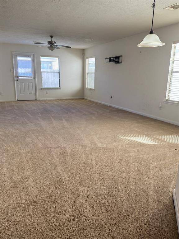 Large kitchen with space for bar stools. Refrigerator Stays.