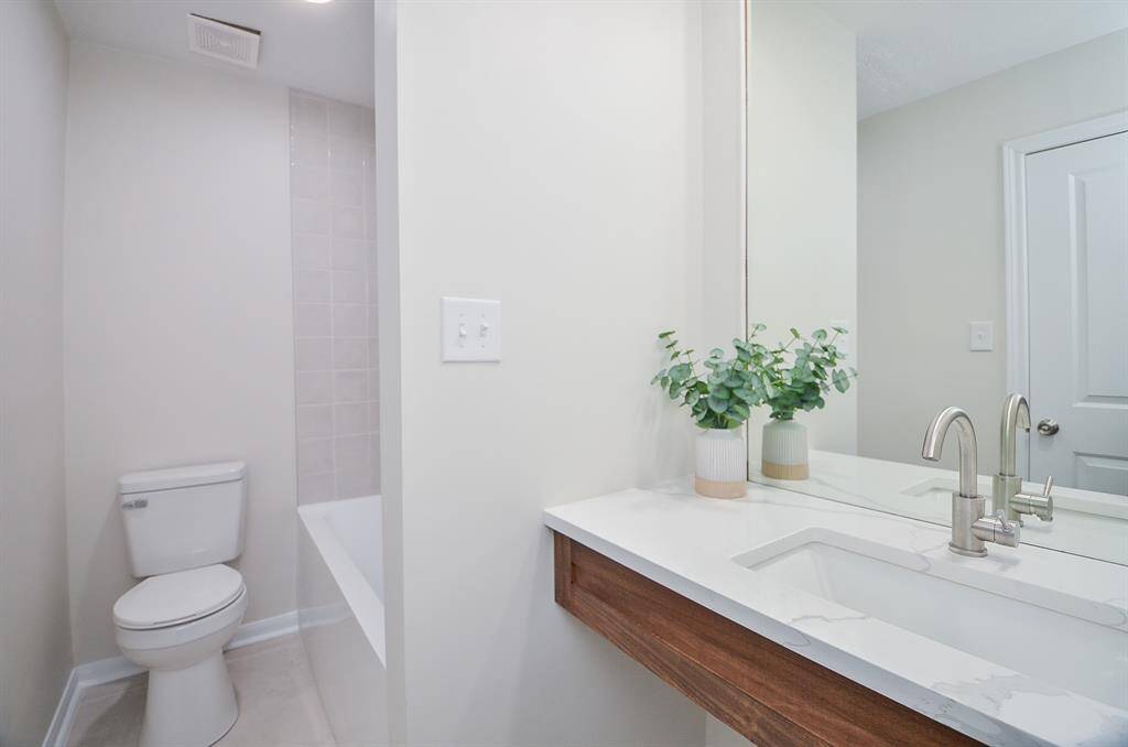 Custom floating vanity in secondary bathroom