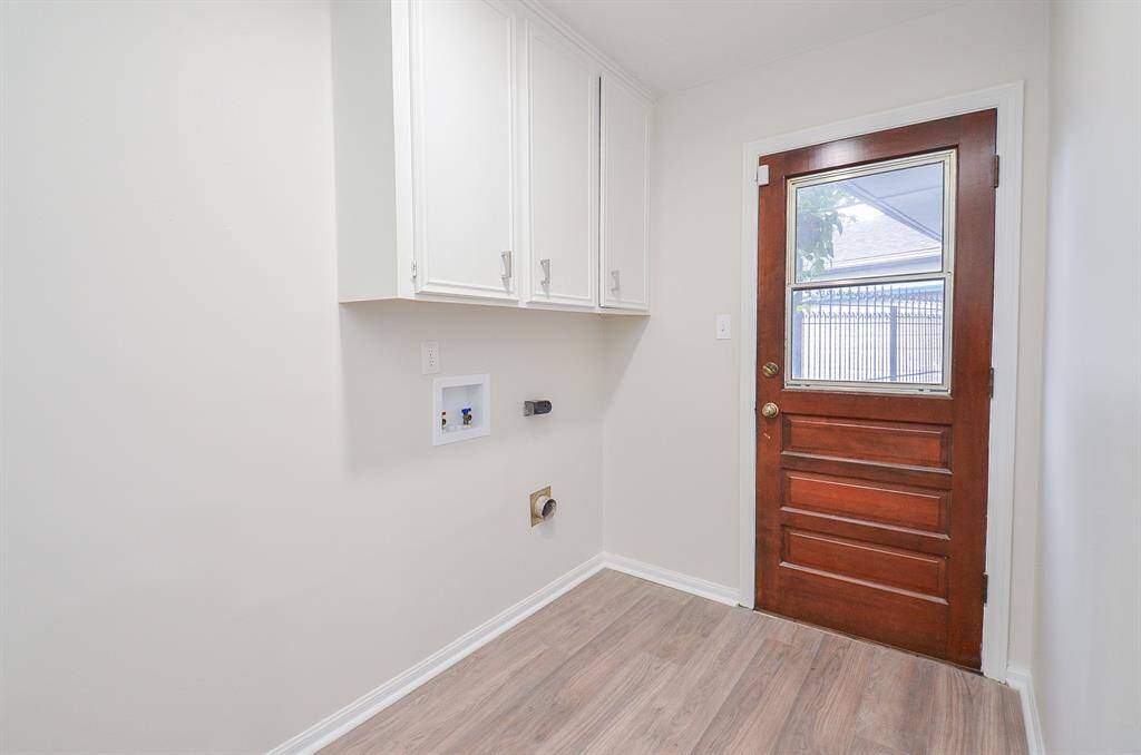 Laundry room with washer and dryer connections. Backdoor leads to covered breezeway for detached 2-car garage.