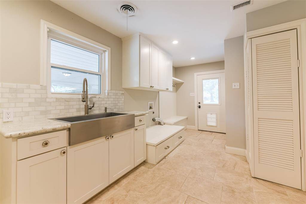 Laundry room with shower/large sink/more built in cabinets