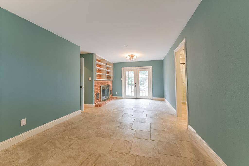 primary bedroom with fireplace and frenchdoors