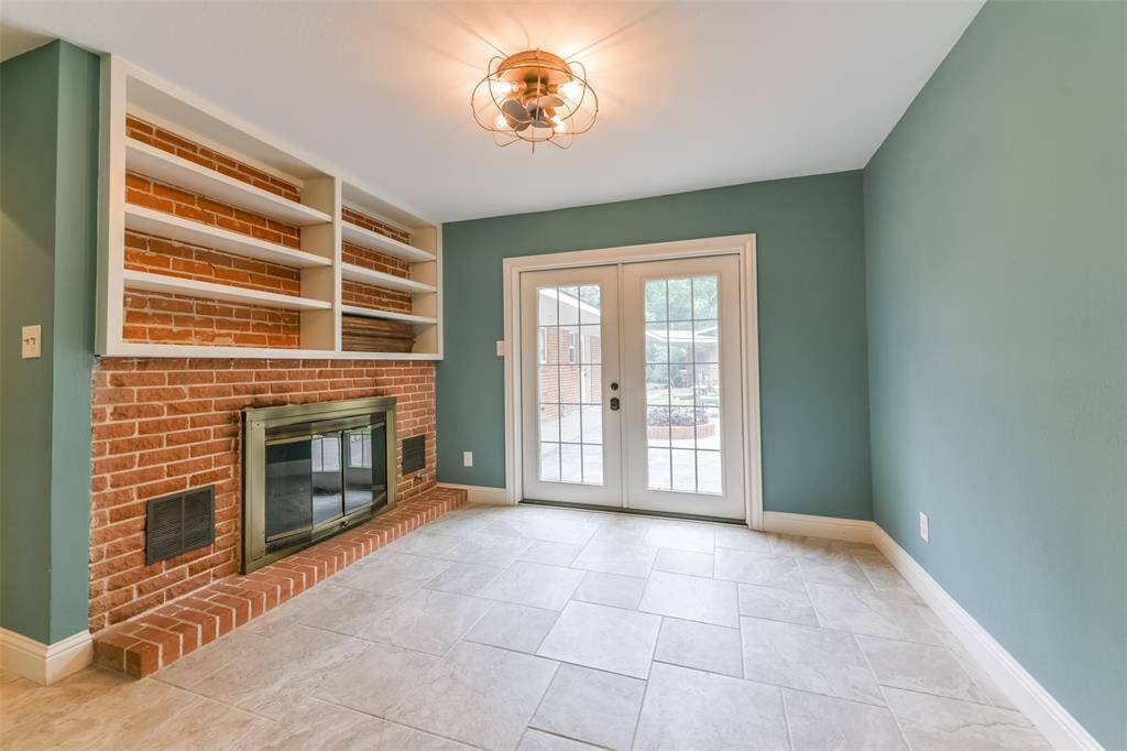 primary bedroom with fireplace and Frenchdoors