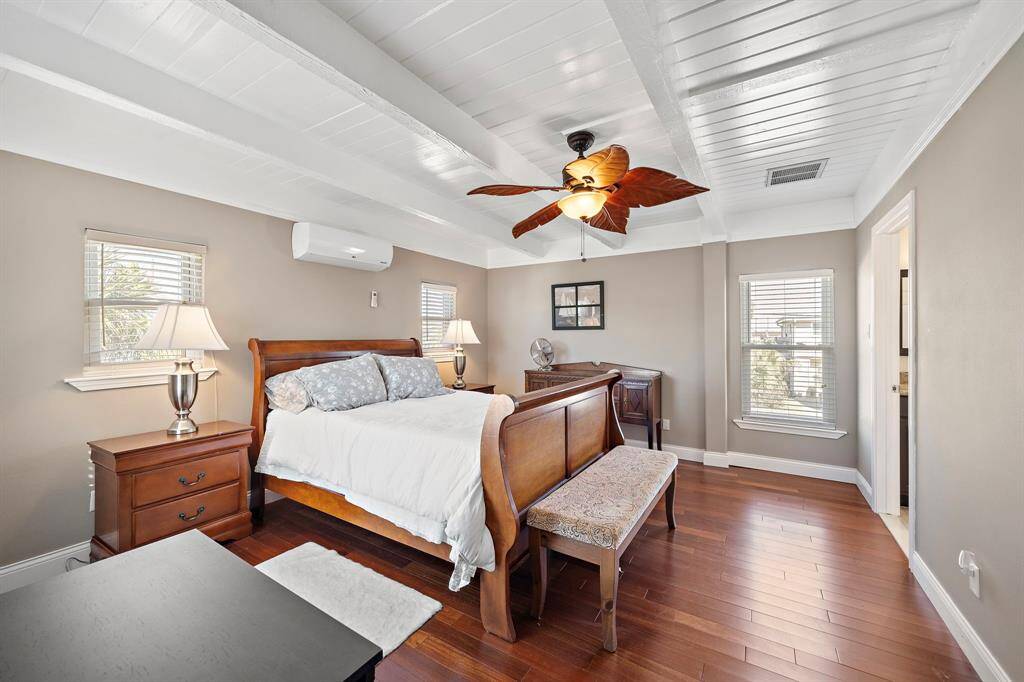 Here, the primary bedroom’s size and light are on full display. Dual nightstands and a bench add both functionality and charm, while the neutral tones make it an inviting place to relax.