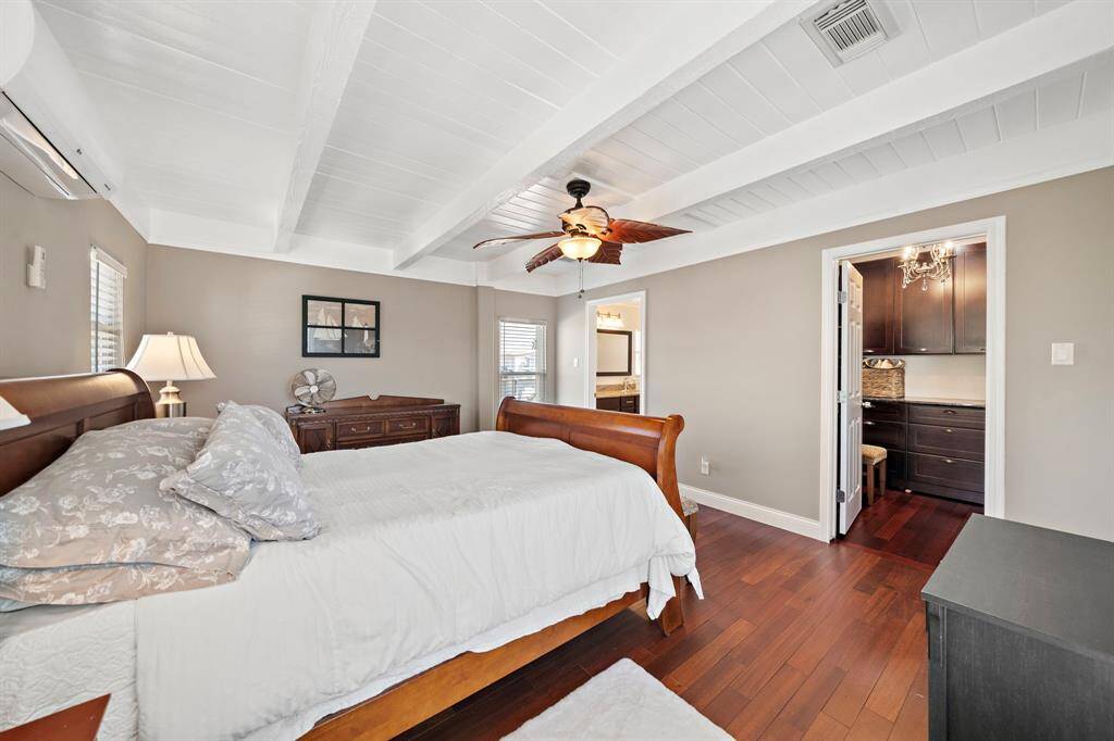 A beautifully appointed primary suite with elegant hardwood floors. Also, a generous walk-in closet and en suite bath, offering both luxury and privacy.
