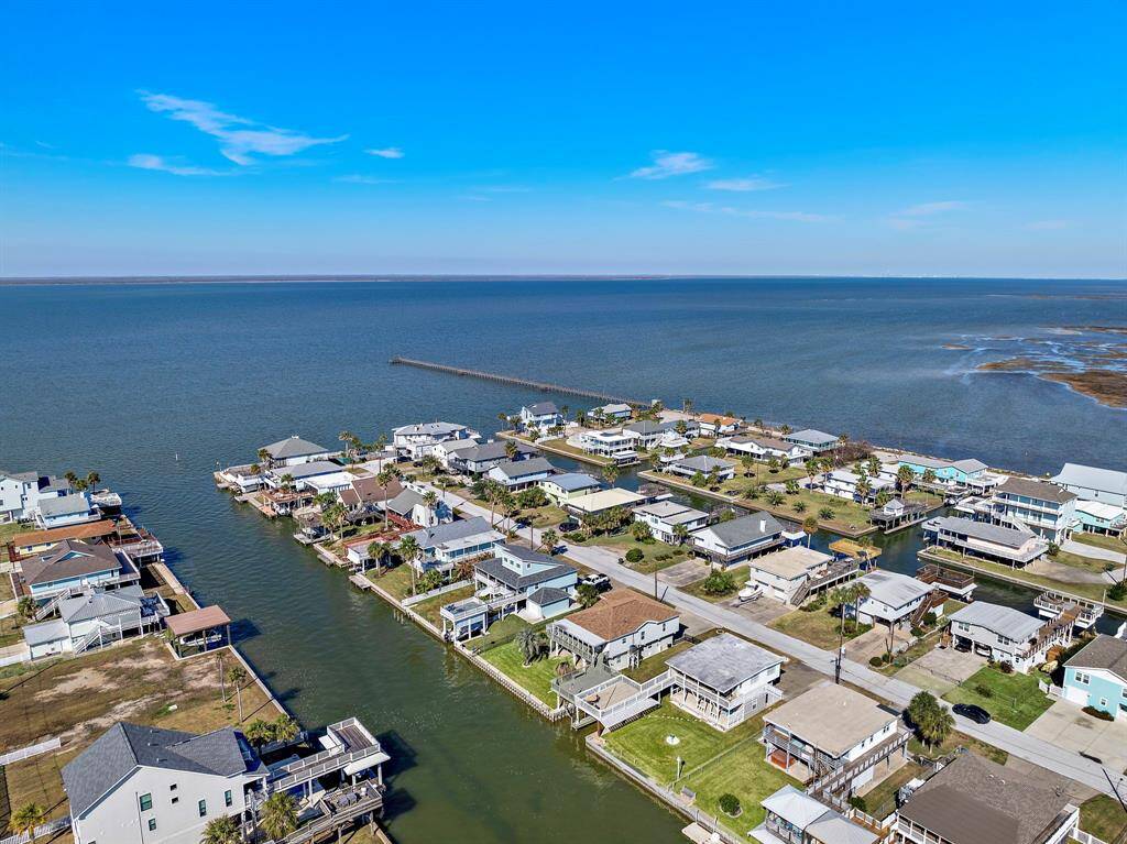 Breathtaking panoramic view of the widest canal in Sea Isle leading out to Galveston Bay. This prime waterfront location not only offers quick access to open water but also showcases the serene beauty of coastal living. Perfect for boating, relaxing, or simply enjoying the view from your deck