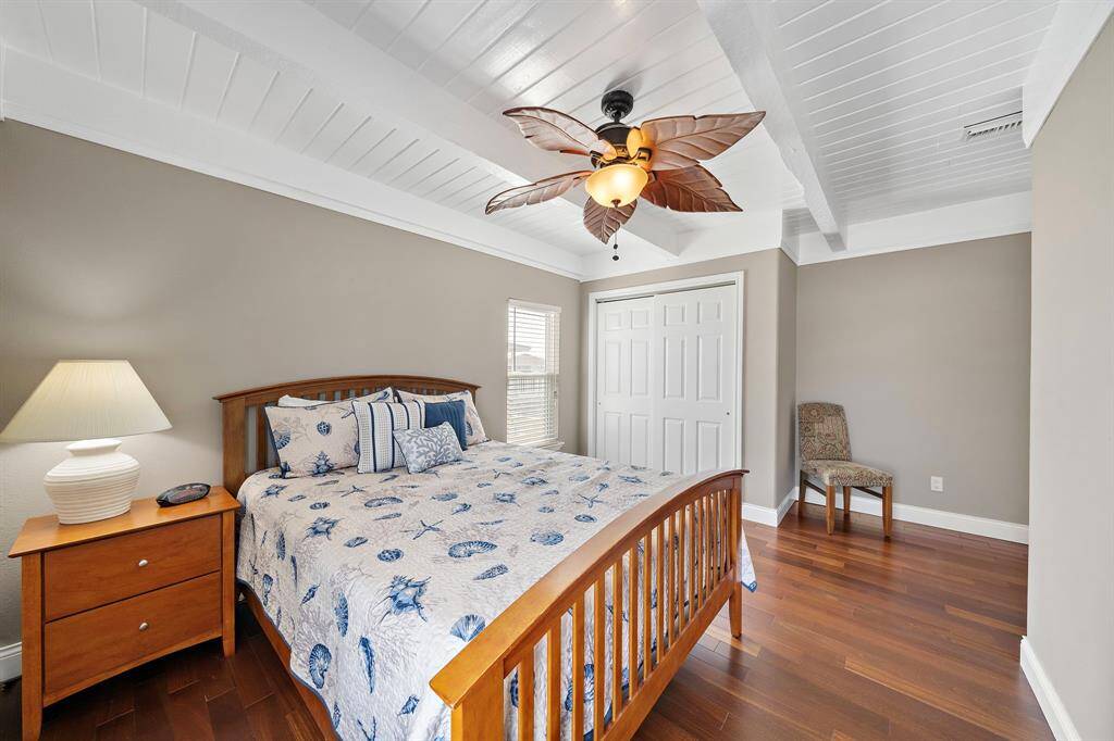 This angle highlights the double-door closet and ample space within the guest bedroom.