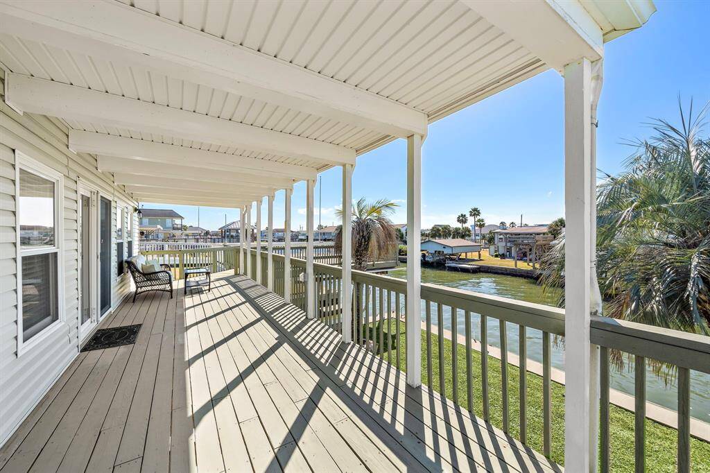 This extended covered deck offers a wide, unobstructed view of the canal and surrounding homes. With ample space for seating and entertaining, it's ideal for taking in the coastal breeze and watching boats pass by.