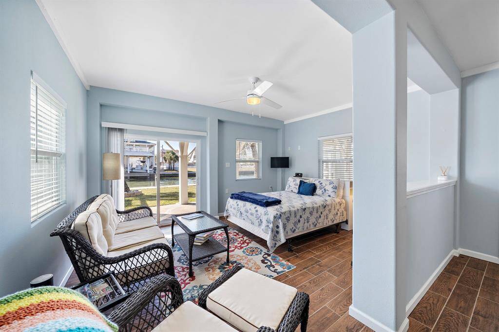 Another angle of the bright and airy in-law suite living/sleeping space, highlighting the seamless flow to the outdoor area, ideal for guests or multi-generational living.