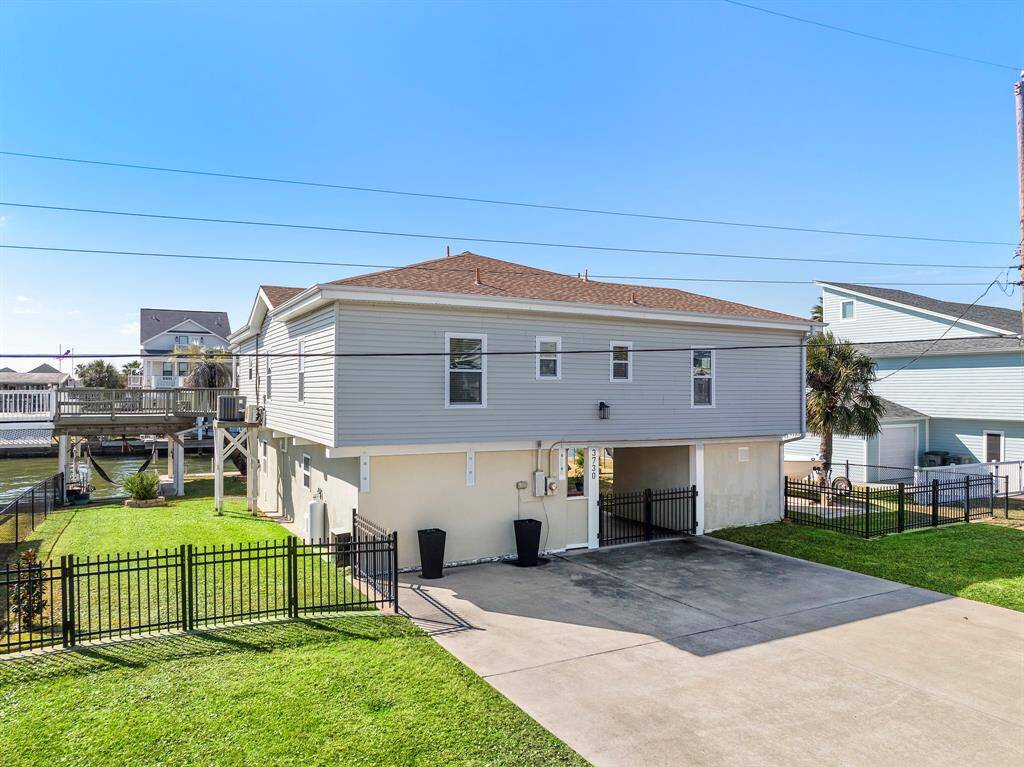 This angled perspective shows off the spacious lot and side yard access, along with the elevated home design—ideal for coastal weather. Clean lines and practical features make this property move-in ready and perfect for full-time or vacation living.