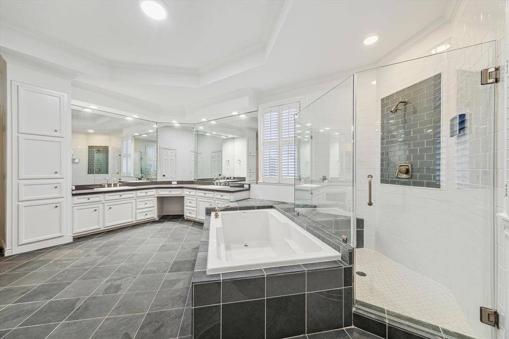 Primary ensuite. Luxurious walk-in shower, oversized, soaking tub, double sinks with vanity seating.