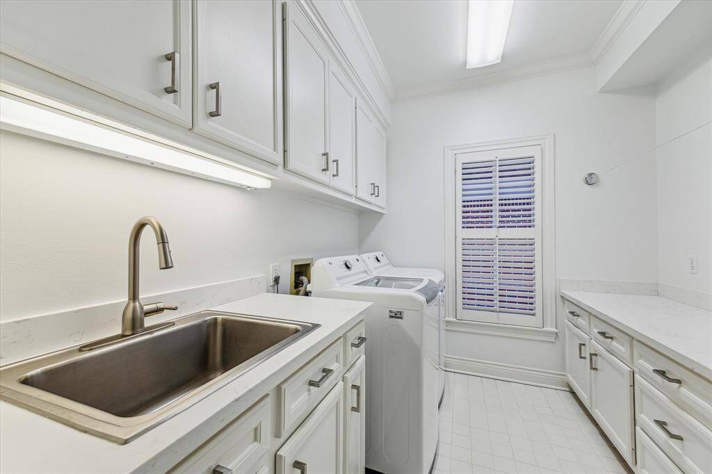 Laundry 2nd Floor. Centrally located in hallway. Includes oversized sink, folding table, abundance of storage.