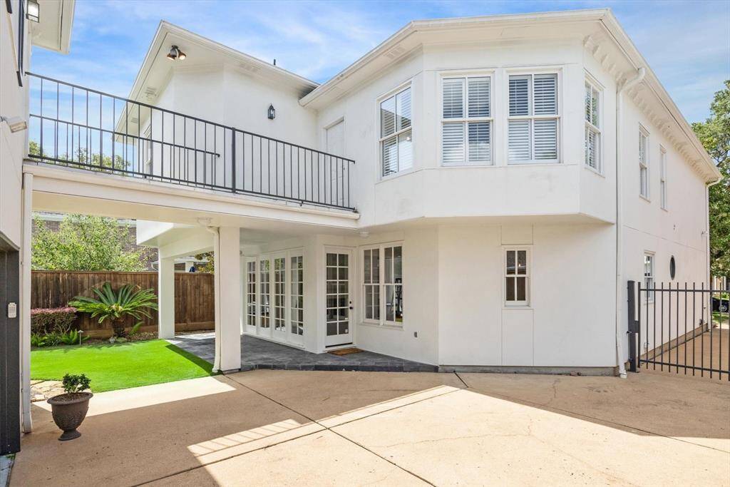 Outdoor slate and iron balcony. seamlessly connects the primary suite in the main house to the guest quarters above the garage. The guest suite is a dynamic space which could serve many purposes.