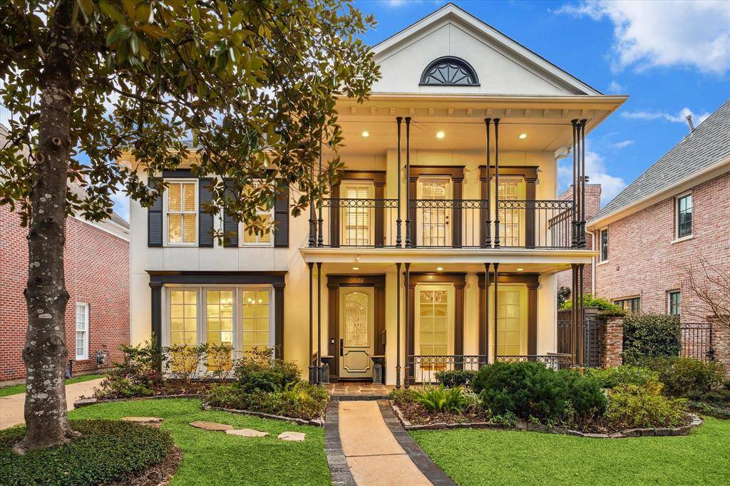 Lighted exterior front porch and 2nd floor balcony.