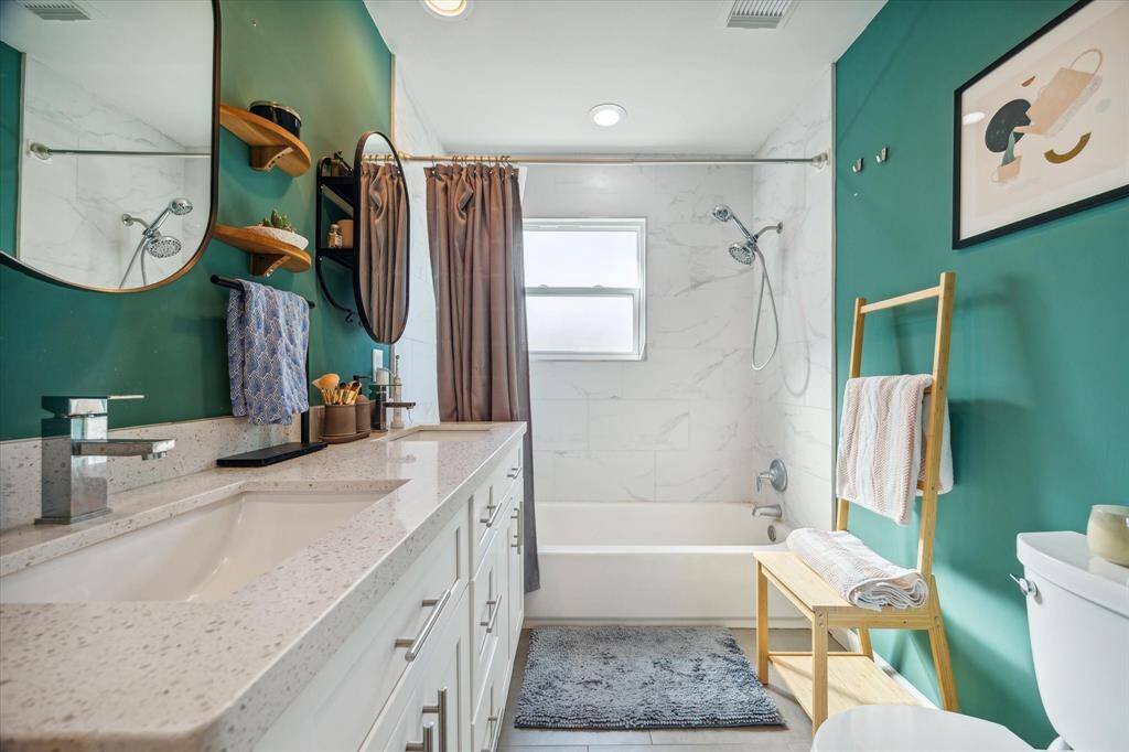 Bedroom #2 is positioned off of the living room and is currently being utilized as an office. The room features white oak hardwood floors, large windows, recessed lighting, MoMa ceiling fan, generous closet, and a full ensuite bath.