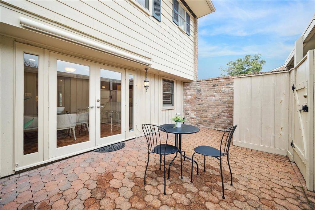 The paved back patio is an ideal space for entertaining guests or simply relaxing and enjoying the outdoors.