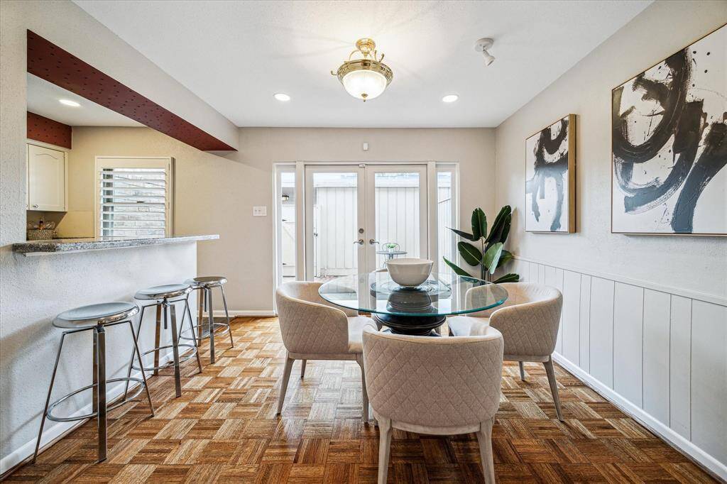 The kitchen & dining area overlook a paved patio, providing an outdoor extension for gatherings.