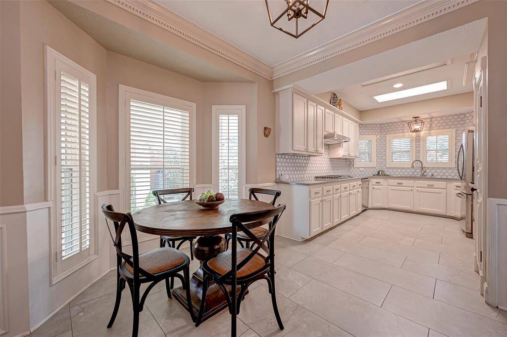 A doorway from the living room seamlessly connects to the kitchen, which also includes an inviting eat-in breakfast area.