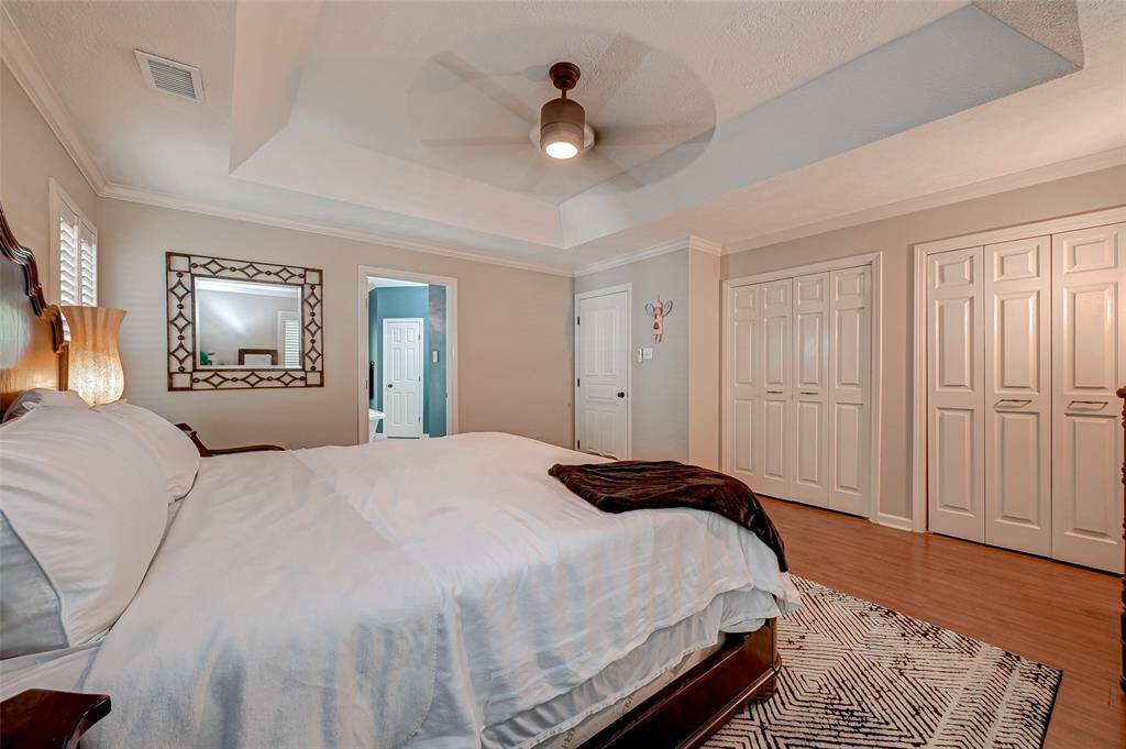 The first-floor owner's suite is not only spacious and stylish but also boasts a remarkable feature – it offers 4 CLOSETS, providing ample storage and exceptional organizational options to meet your needs.