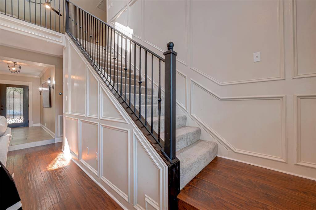 The staircase leads to the second floor, where you'll find that carpeting has been installed, not only for comfort but also for effective sound control, ensuring a quieter and more peaceful environment.
