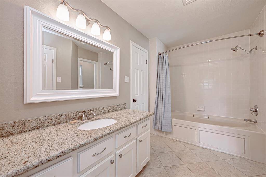 Bedroom #2's ensuite bath (Bath #2) spans 16.0x5.11 and features a single sink set in a long GRANITE countertop. A framed mirror and updated lighting add to its appeal. This bathroom offers 2 LIGHTED, WALK-IN CLOSETS, and an additional linen closet. It boasts a JETTED TUB with tiled shower walls for a relaxing bathing experience and a PRIVATE WATER CLOSET with a commode for added privacy.