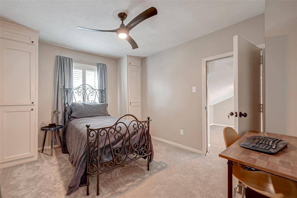 Opposite Bathroom #3, you'll find Bedroom #4, which measures 12.7x10.5. A window with Plantation shutters offers a peaceful view of the backyard, and a ceiling fan provides comfort. On each side of the window, there are 2 closets for storage. What sets this room apart is its CONNECTING DOOR TO A "FLEX" SPACE or extra room, adding versatility and potential for various uses.