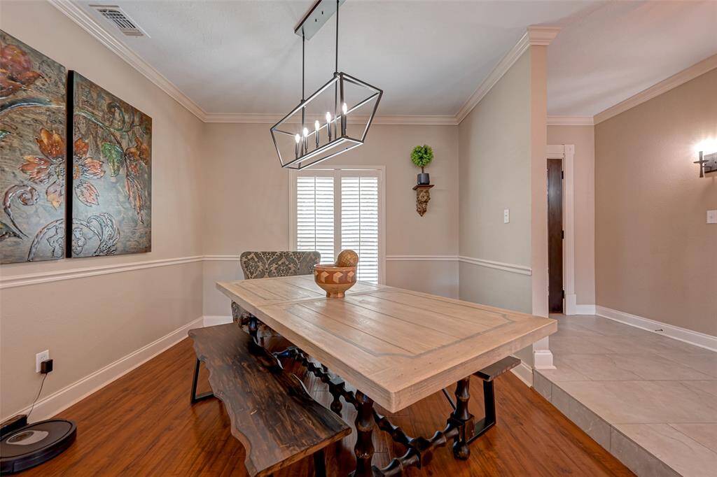 The dining area, measuring 11.9x10.11, boasts fantastic wall space, ideal for displaying a China hutch or setting up a serving buffet. A window adorned with Plantation shutters offers a pleasant view of the front yard. Seamlessly connected to the living area, this space creates an inviting atmosphere, perfect for entertaining family and friends in an open and welcoming setting. Enjoy the art of hospitality in style.