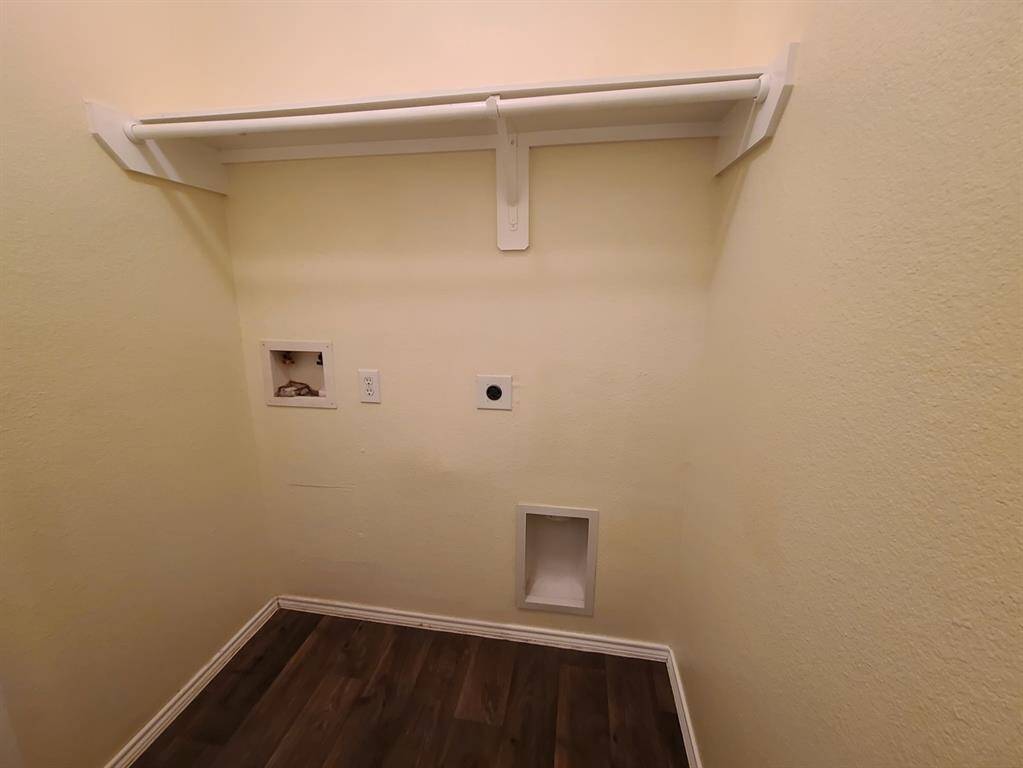 In home utility room with washer and dryer connections.