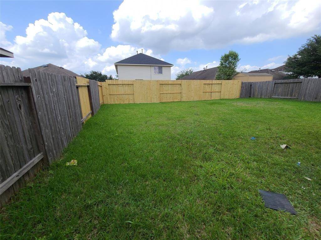 Spacious, yet easy to maintain back yard with new fencing.