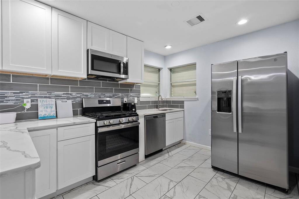 Updated Kitchen with Calacatta Counters and Stainless Steel Appliances