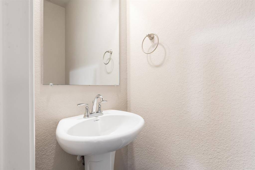 Half bathroom located by the garage entry and living area.