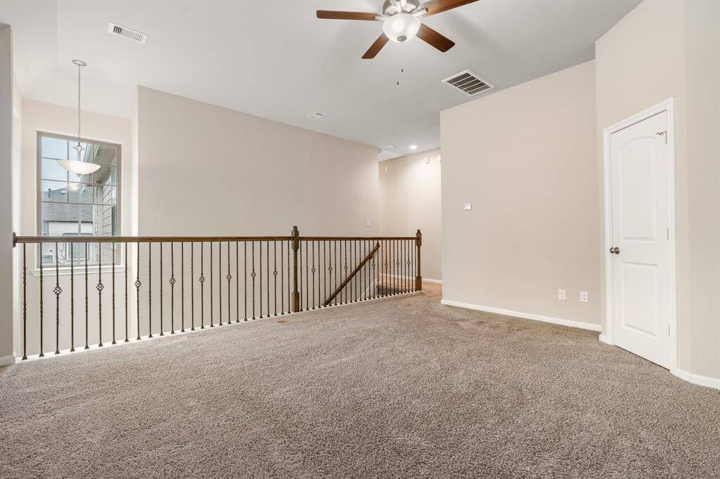 This spacious game room offers a unique view of the entry below, creating an open, airy feel.