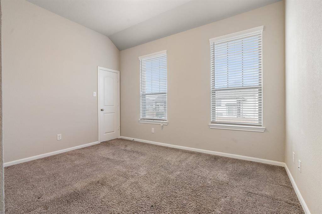 2nd bedroom upstairs overlooking the front of the home.  This bedroom features a walk-in closet with a window of it's own.