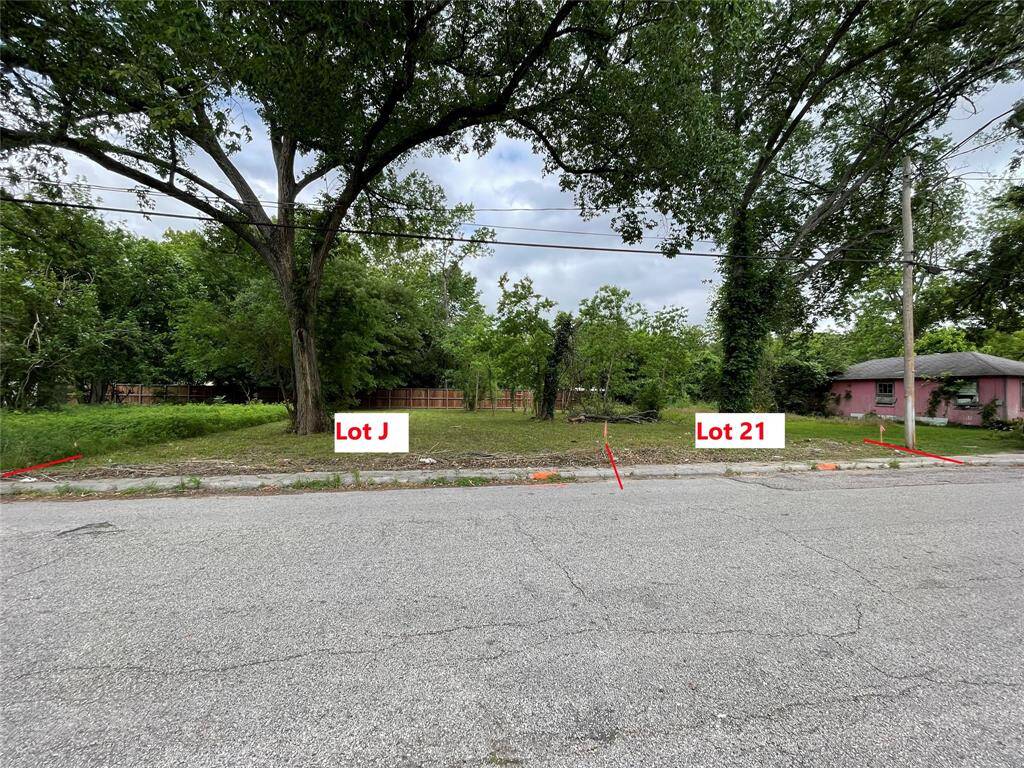 Lot J is 40' wide, and Lot 21 is 30' wide. Total frontage of 70' with sidewalks and a curb.