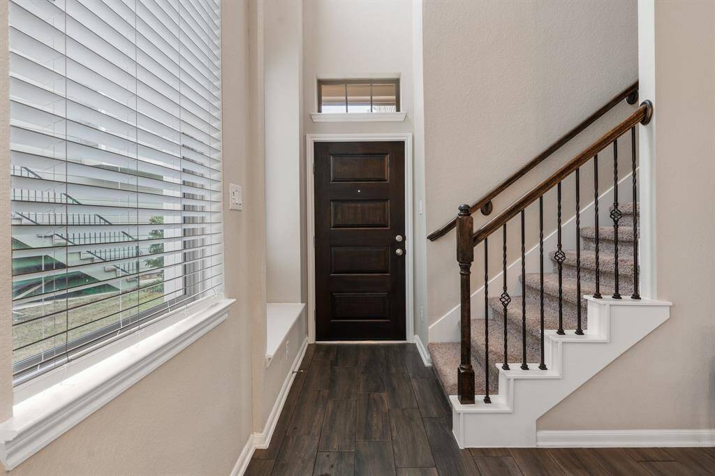 Step into this warm and inviting entry, complete with a quaint window nook perfect for reading or enjoying the view.