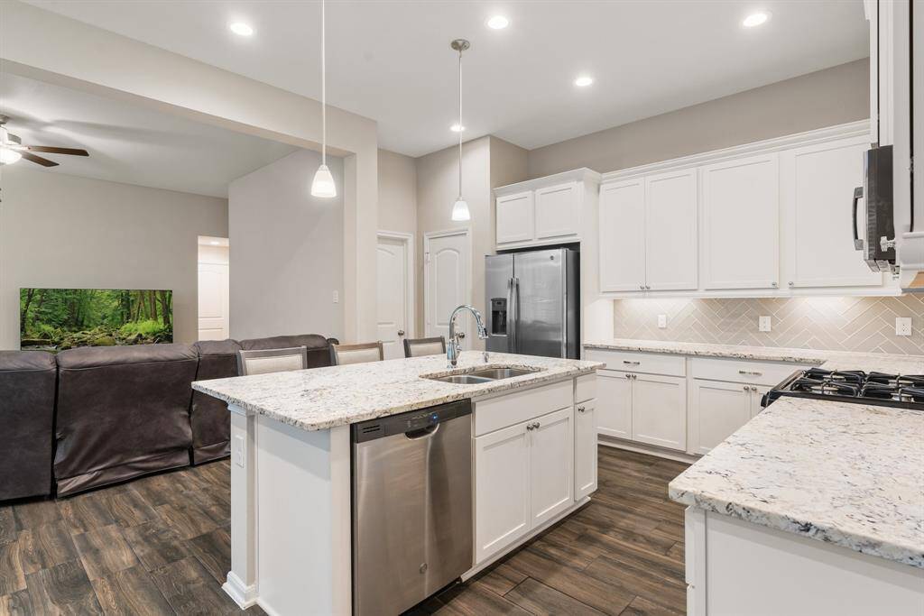 The kitchen seamlessly flows into the spacious living room, creating the ideal layout for cooking, entertaining, and enjoying time with family and friends.