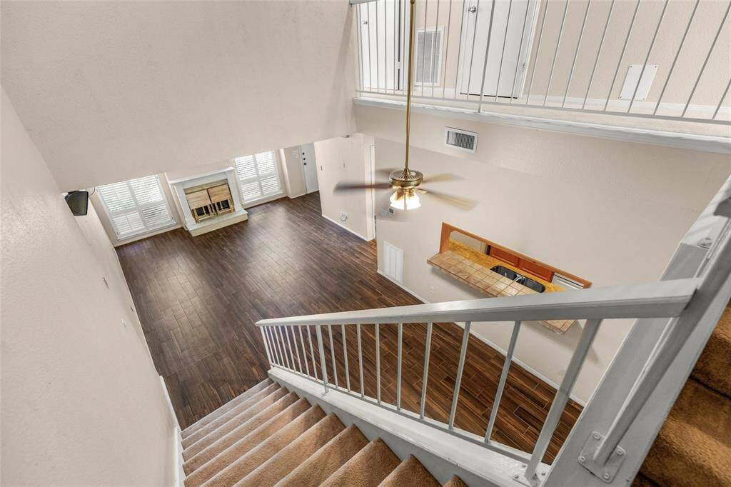 Looking into the living room from the stairwell that leads to the two bedrooms upstairs.