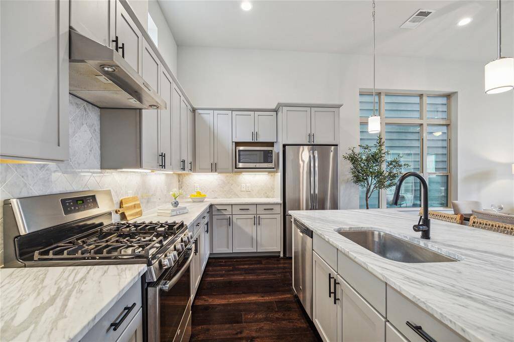 The kitchen feels endless! There are stainless steel appliances, and extended counters ready to prep all your gourmet meals!