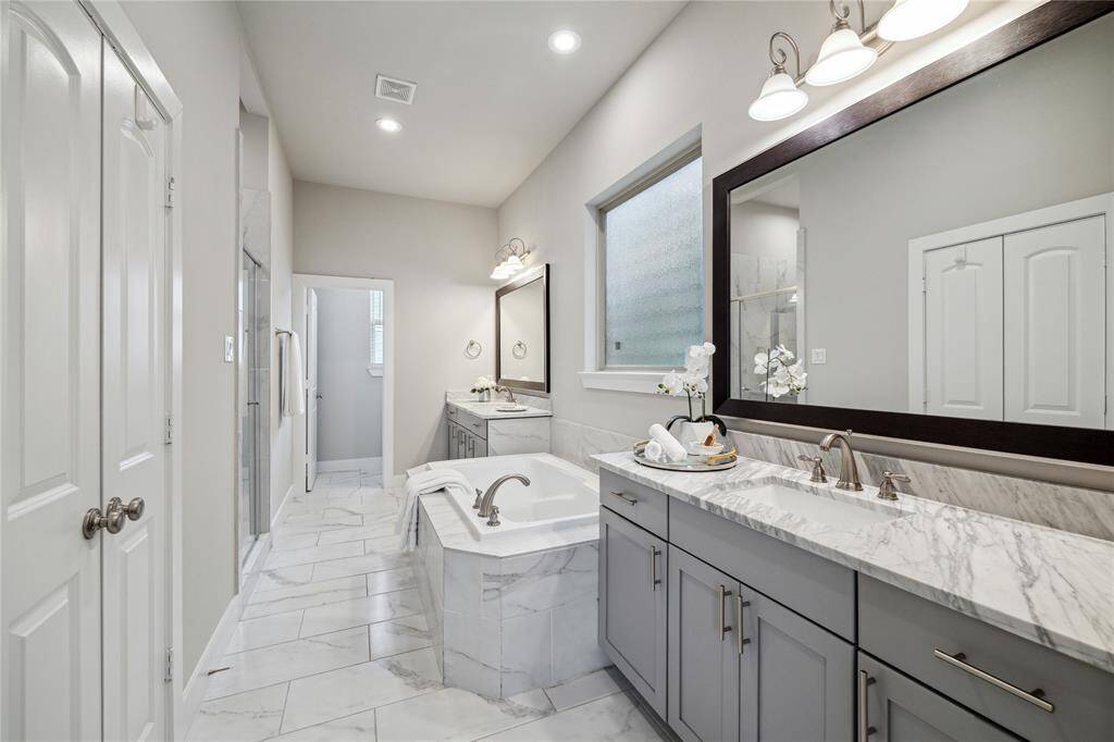 This enormous primary suite rivals the most elegant spas! Enjoy separate tub and shower, and dual vanities with plenty of counter space!