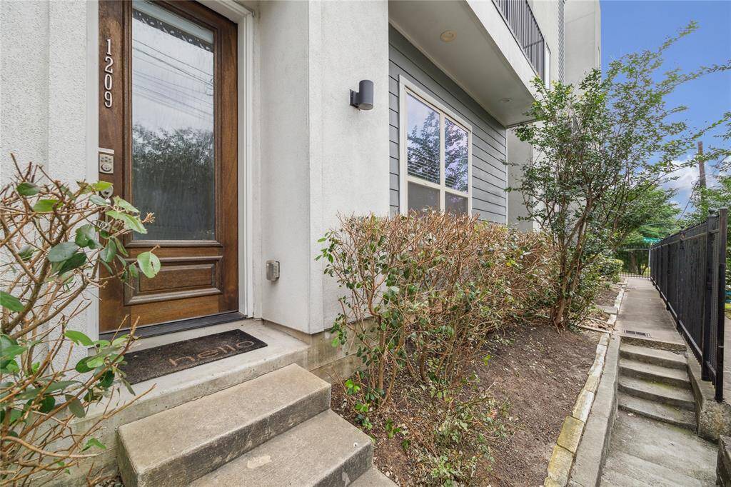 Gated access leads you to a large glass and wood door!