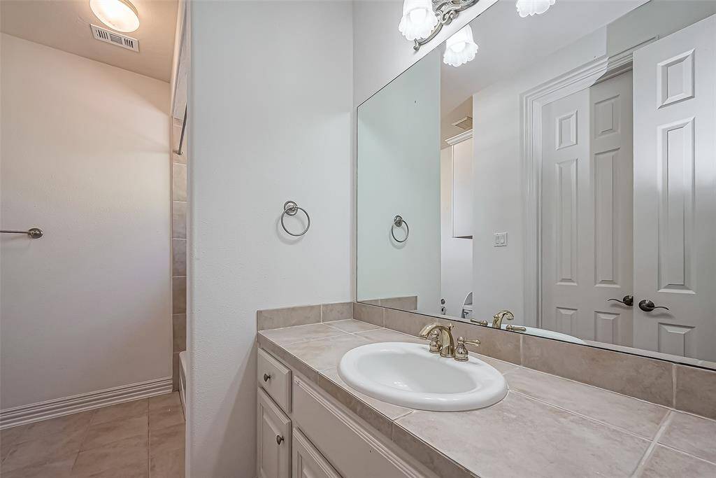 Spacious primary bedroom offers a high tiered ceiling and great views of lake and fountains.